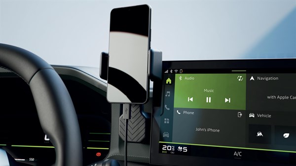 YouClip bežični punjač postavljen ispod kontrolne ploče s pametnim telefonom na punjenju.