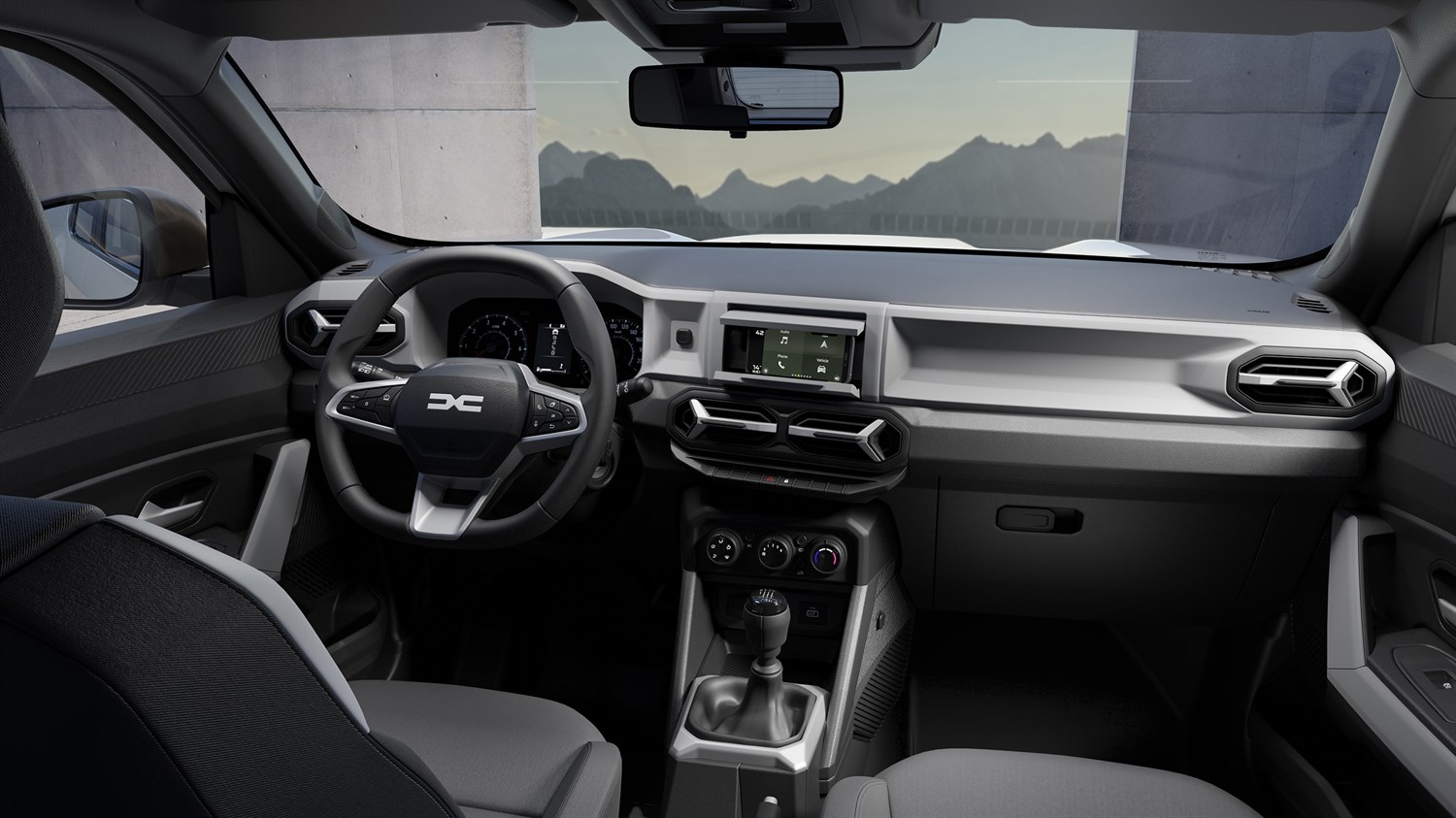 Unutrašnjost vozila Dacia Duster s prikazom volana, središnje konzole i ventilacijskih otvora.