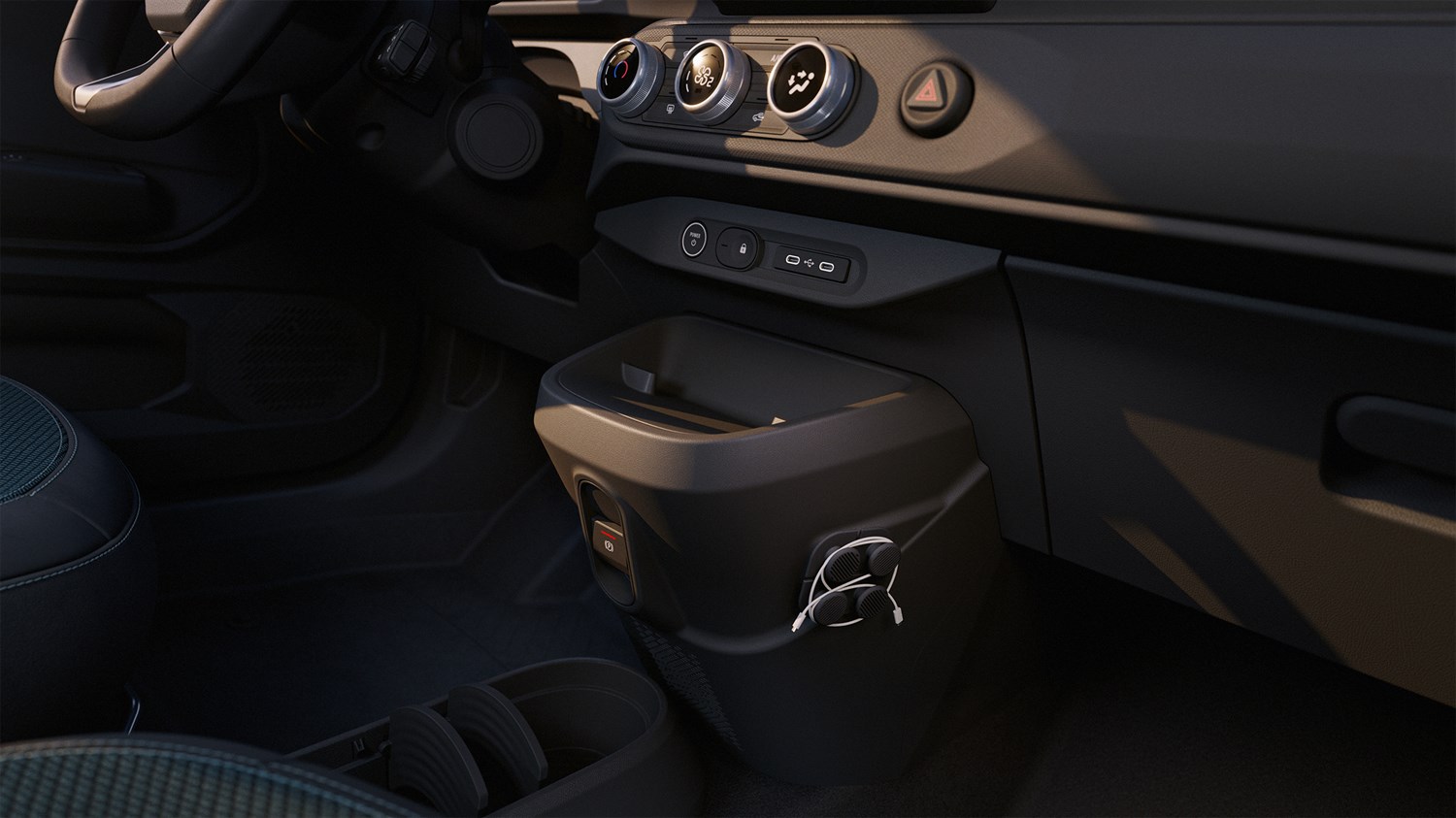 Detalj središnje konzole i pretinca za odlaganje u unutrašnjosti vozila Dacia Spring.